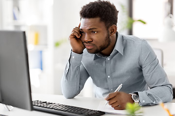 Image showing businessman with computer and papers at office