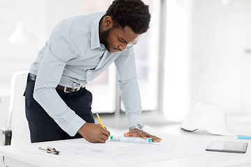 Image showing african architect with blueprint at office