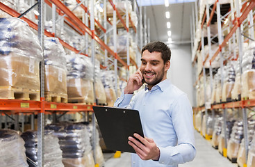 Image showing businessman calling on smartphone at warehouse