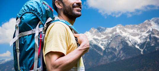 Image showing close up of man with backpack over alps mountains