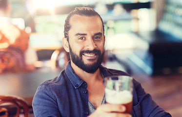 Image showing happy man drinking beer at bar or pub