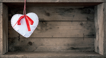 Image showing felt heart on a wooden background