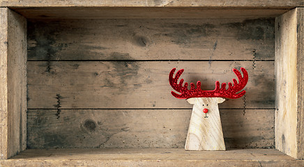 Image showing Christmas symbols decoration wooden reindeer in a wooden box