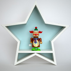 Image showing Christmas decoration white star with funny reindeer figure insid