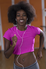 Image showing afro american woman running on a treadmill