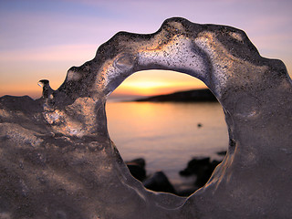 Image showing Sunset through ice's hole