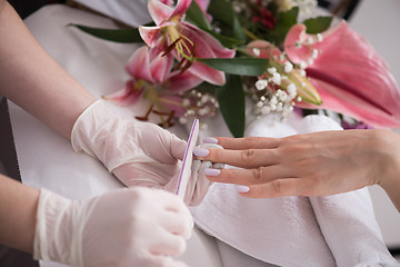 Image showing Woman hands receiving a manicure