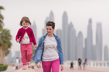 Image showing mother and cute little girl on the promenade