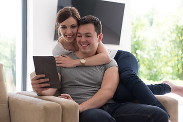 Image showing couple relaxing at  home with tablet computers