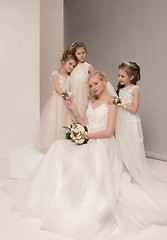 Image showing Little pretty girls with flowers dressed in wedding dresses