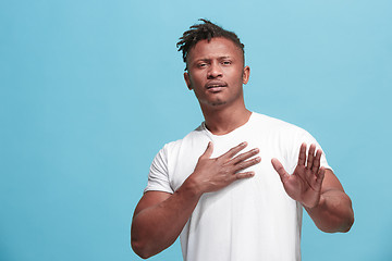 Image showing Young serious thoughtful Afro-American businessman. Doubt concept.