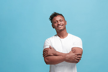 Image showing The happy business afro-american man standing and smiling against blue background.