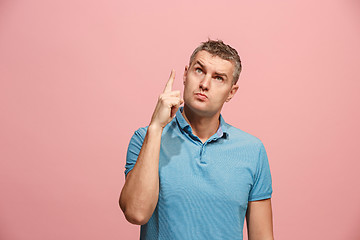 Image showing Young serious thoughtful businessman. Doubt concept.