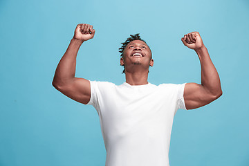 Image showing Winning success afro-american man happy ecstatic celebrating being a winner. Dynamic energetic image of male model