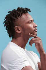 Image showing Let me think. Doubtful pensive Afro-American man with thoughtful expression making choice against blue background