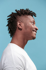 Image showing The crazy business Afro-American man standing and wrinkle face blue background. Profile view.