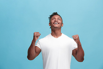 Image showing Winning success afro-american man happy ecstatic celebrating being a winner. Dynamic energetic image of male model