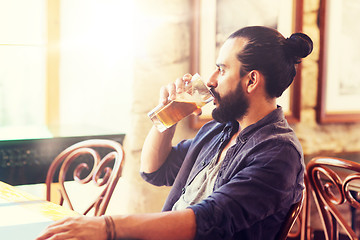 Image showing happy man drinking beer at bar or pub