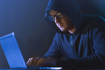 Image showing hacker using laptop computer for cyber attack