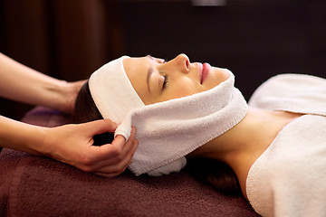 Image showing woman having face massage with towel at spa