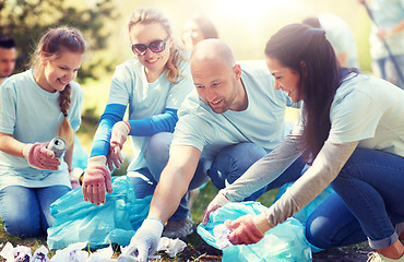 Image showing volunteers with garbage bags cleaning park area