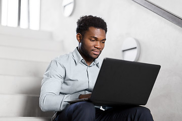 Image showing african american businessman with laptop at office