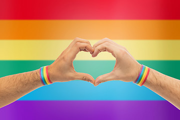 Image showing male hands with gay pride wristbands showing heart