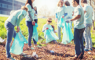 Image showing volunteers with garbage bags cleaning park area