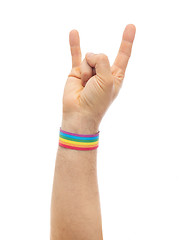 Image showing hand with gay pride rainbow wristband shows rock