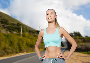 Image showing happy young woman doing sports outdoors