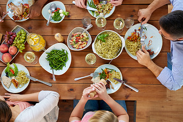 Image showing group of people eating at table with food