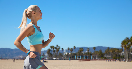 Image showing woman with fitness tracker running