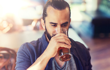 Image showing happy man drinking beer at bar or pub