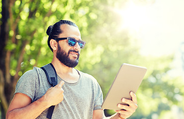 Image showing man traveling with backpack and tablet pc in city