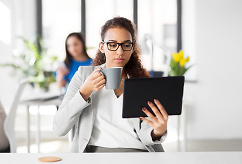 Image showing businesswoman with tablet pc and coffee at office