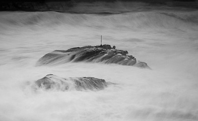 Image showing Rock fighting to stay above the huge swells Cape Banks Australia