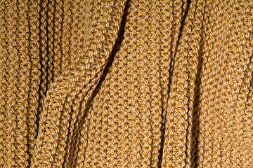 Image showing Yellow wool knitted scarf closeup.