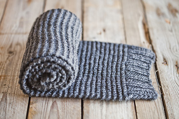 Image showing Hand knitted gray scarf.