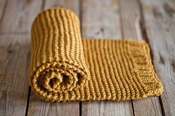 Image showing Hand knitted yellow scarf.