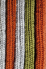 Image showing Orange, green and grey wool knitted texture.