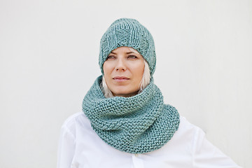 Image showing Woman in warm turquoise knitted hat and snood.