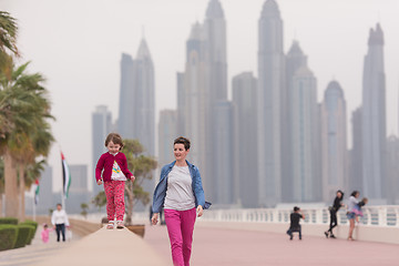 Image showing mother and cute little girl on the promenade