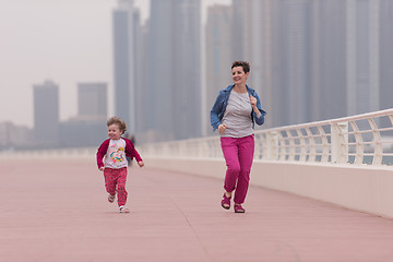 Image showing mother and cute little girl on the promenade