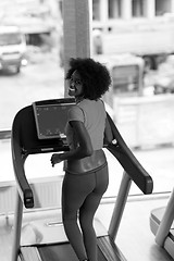 Image showing afro american woman running on a treadmill