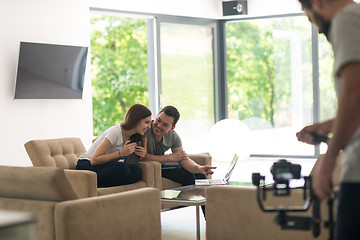 Image showing couple relaxing at  home with tablet and laptop computers