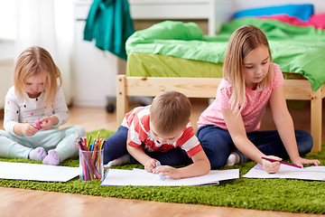 Image showing happy kids drawing at home