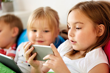 Image showing little kids with smartphone in bed at home