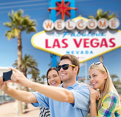 Image showing group of happy friends taking selfie by cell phone