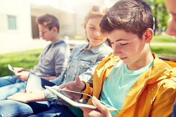 Image showing happy friends or students with tablet pc outdoors