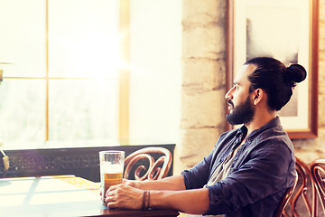 Image showing happy man drinking beer at bar or pub